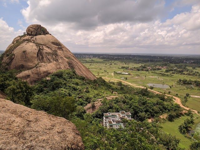 Waterfall cascading down rocky cliffs with lush green vegetation in Purulia's hills